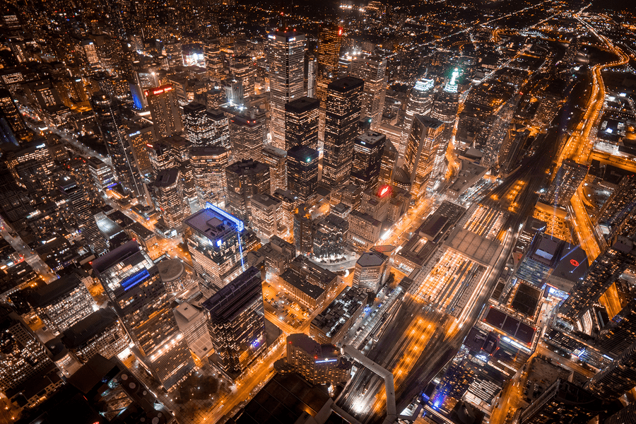 An aerial-view image of the city of Toronto downtown core at night, showing the busy business district and high-rise buildings.